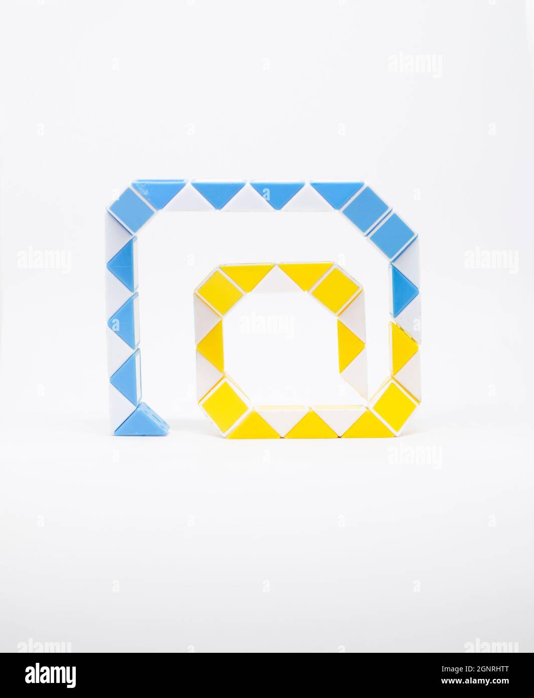 Arobase symbol made of yellow, white and blue triangles on a white ...