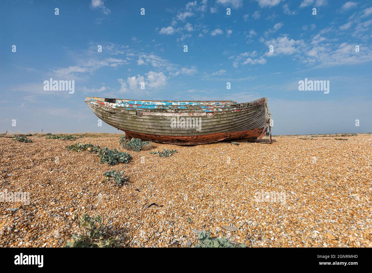A derelict abandoned wooden boat on a shingle beach Stock Photo - Alamy
