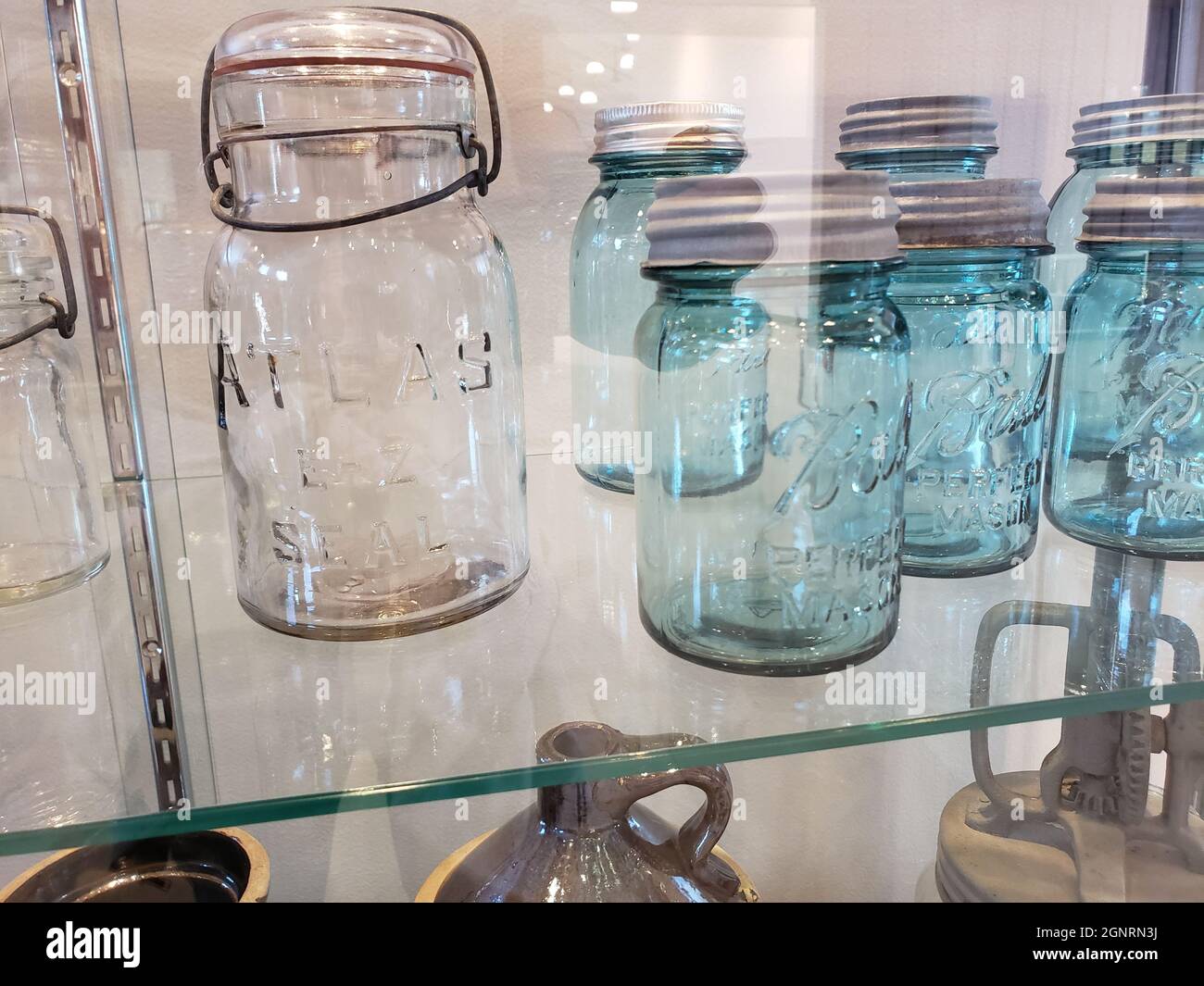 Bluish Glass Jars in a Display Case Stock Photo
