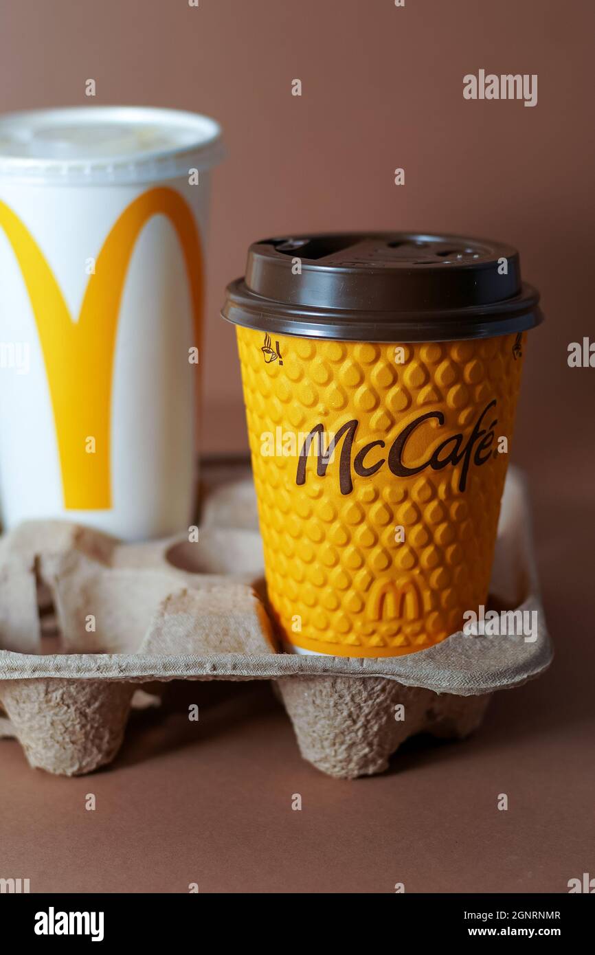 Yellow glass of coffee McDonald's. Paper glass drink Mc Cafe. Two cups