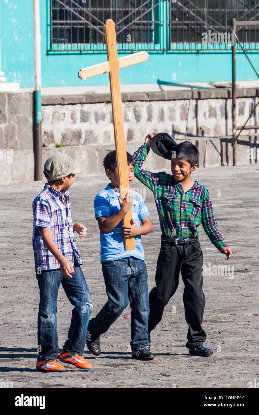 SANTIAGO ATITLAN, GUATEMALA - MARCH 24, 2016: Small boys with a cross in Santiago Atitlan. Stock Photo