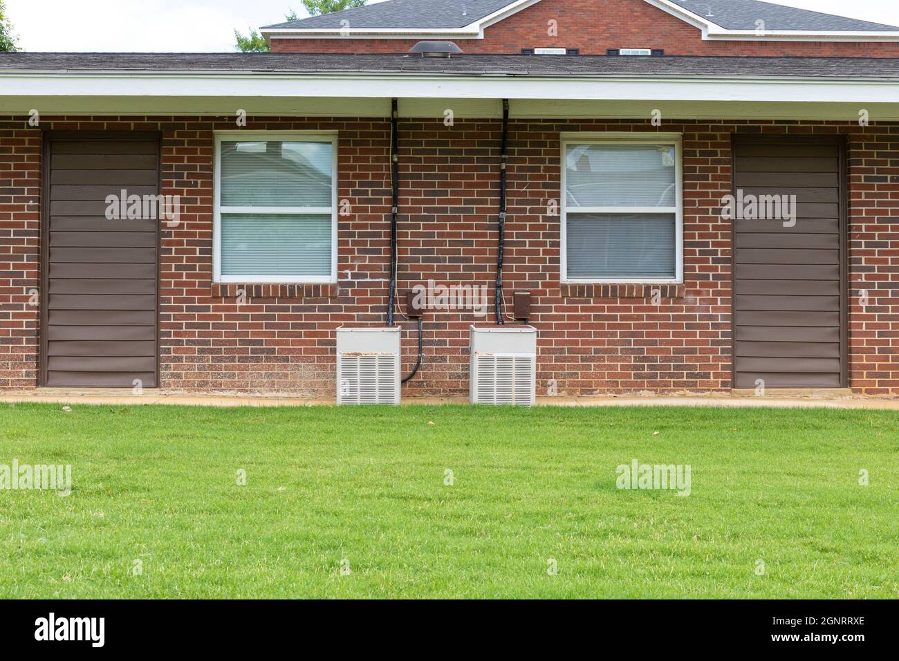 Exterior view of a generic apartment building with older model HVAC ...