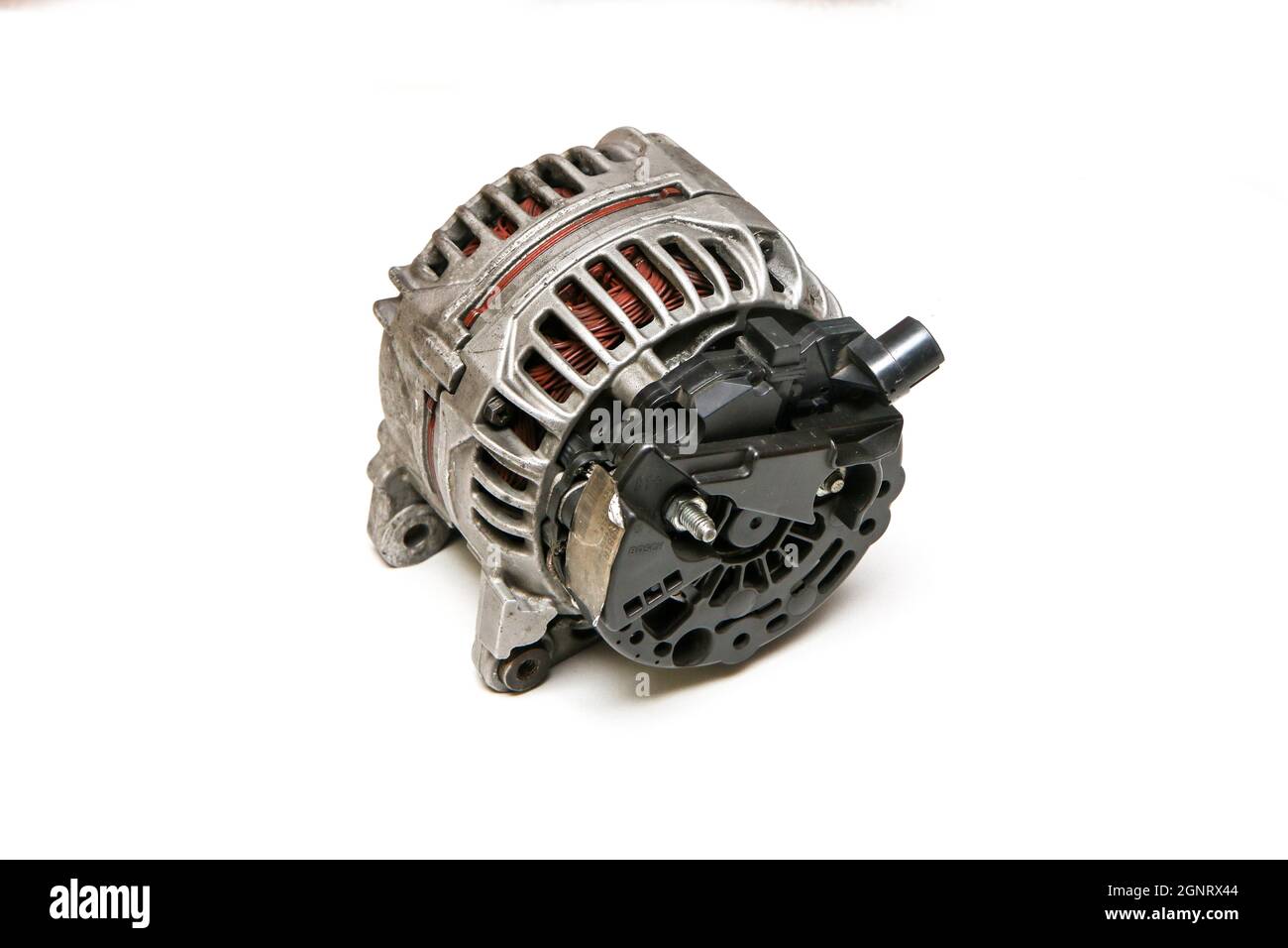 The old used and broken alternator from the motor vehicle isolated on a