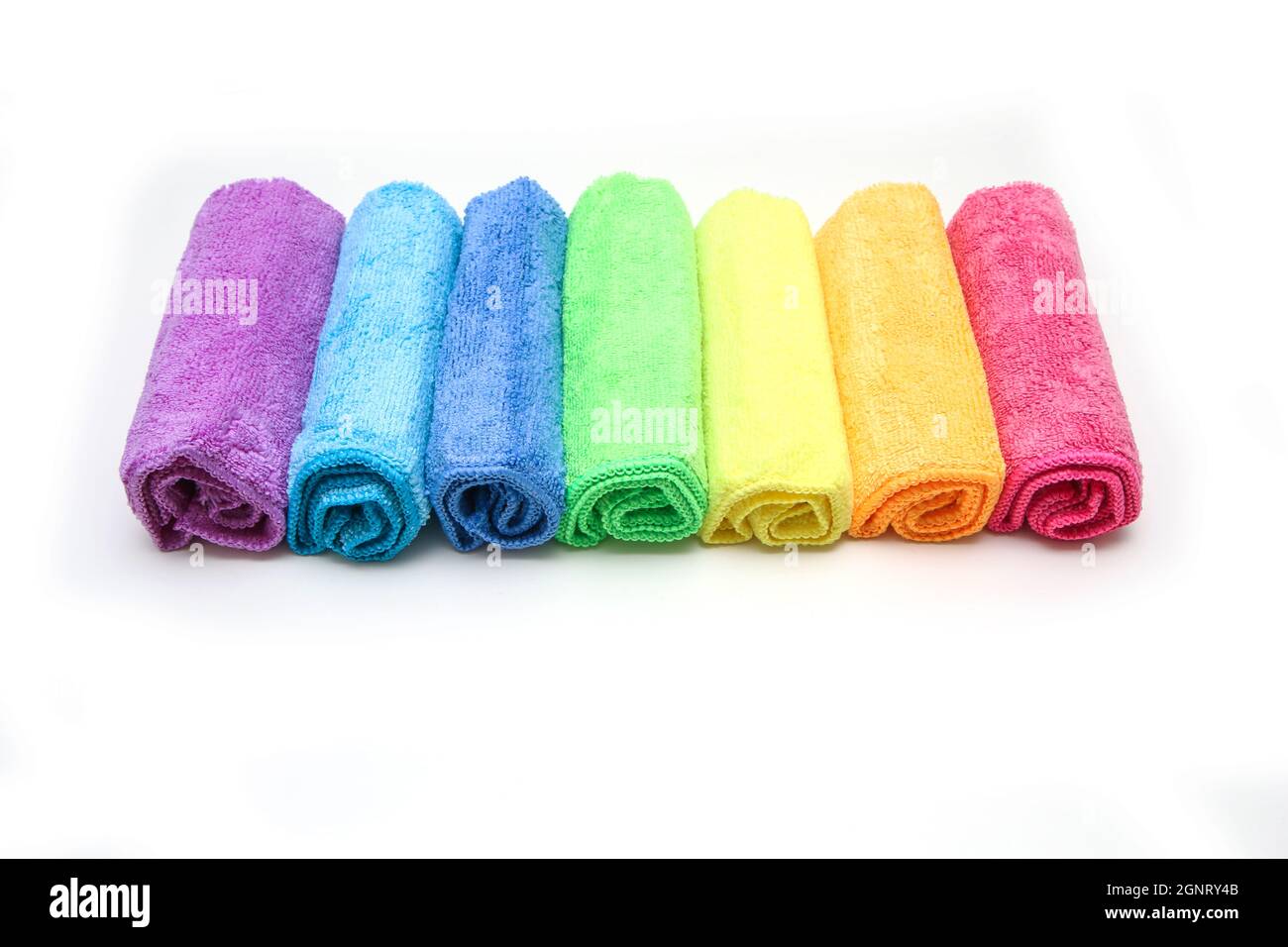 The row of the different colorful micro fibre rags ordered in a white background. Stock Photo
