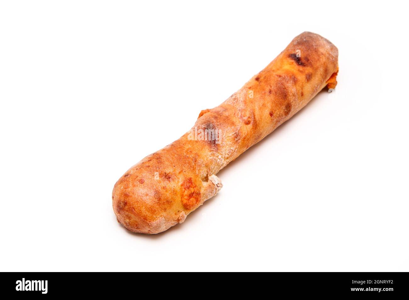 Single piece of bakery, the crunchy stick with mimolette cheese isolated in a white background. Stock Photo