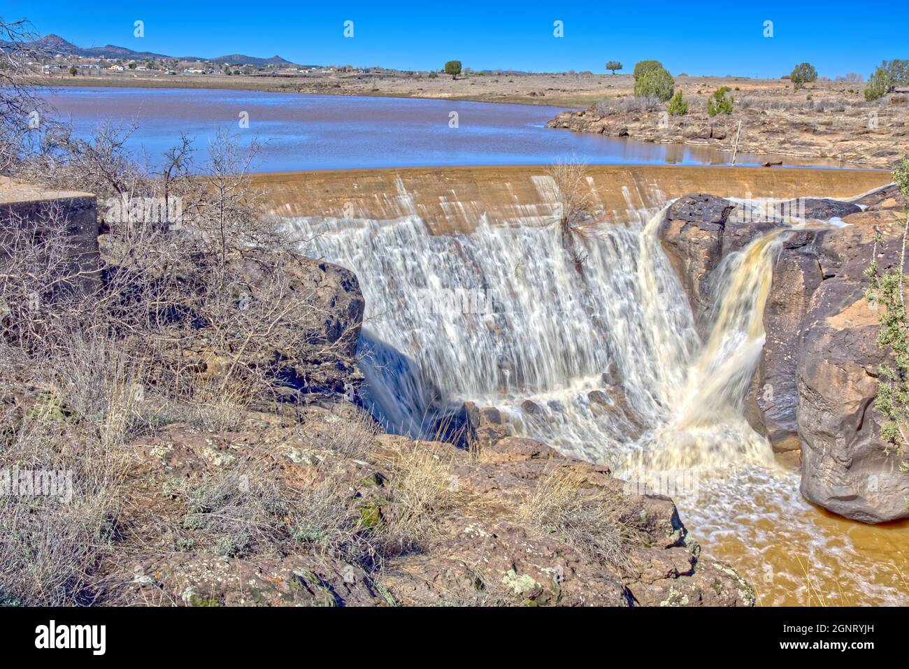 The Historic Sullivan Dam in Paulden AZ was part of a WPA project back in the 1930s. It was abandoned when World War 2 broke out. Sullivan Lake behind Stock Photo