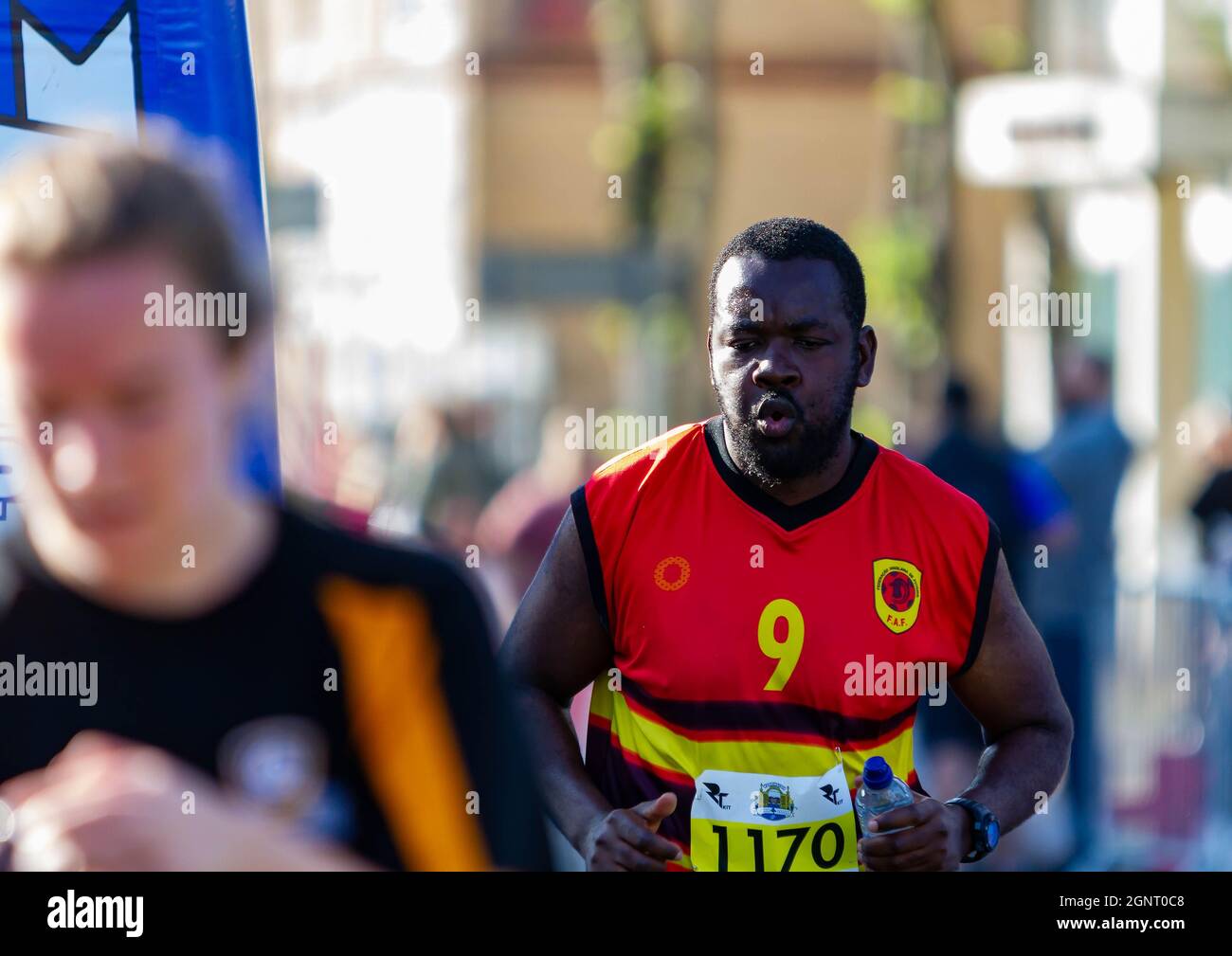 Warrington Running Festival 2021 - man gasps as he crosse the line Stock Photo