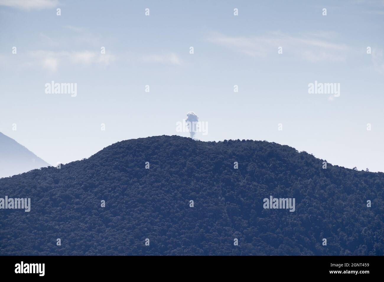 Eruption of volcano Fuego hidden behind volcan Toliman, Guatemala Stock Photo