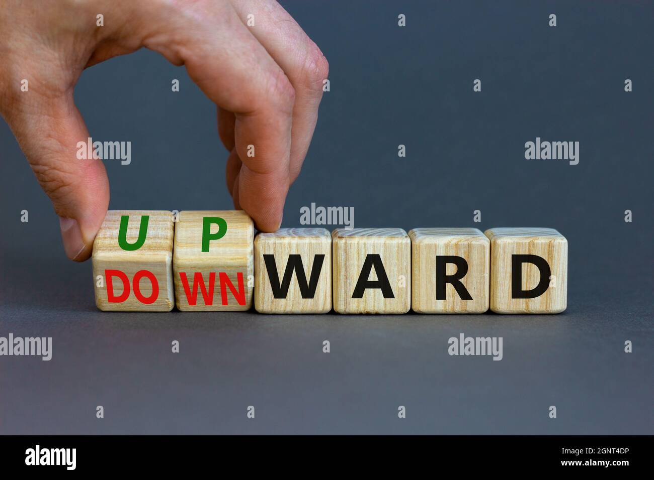 Upwards Table Upward or downward symbol. Businessman turns wooden cubes and changes ...