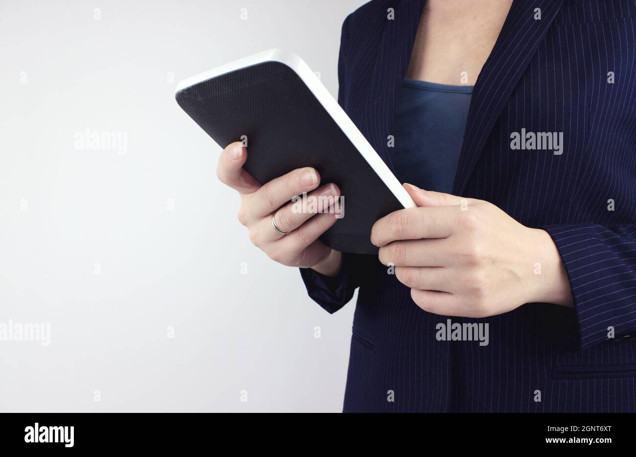 Concept of technology, connection, communication, social. Businesswoman hand using digital tablet. Hands Holding A Tablet Touch Computer. Digital mark Stock Photo