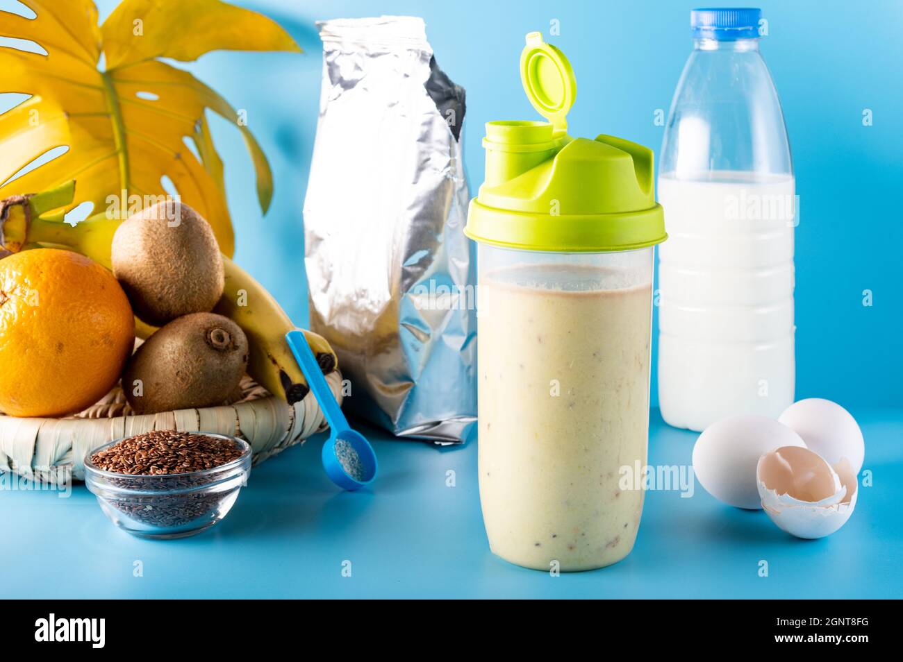 Protein powder and fruit. Protein and milk packaging. Milk products. Protein drink in a shaker. Fruit and protein. Stock Photo