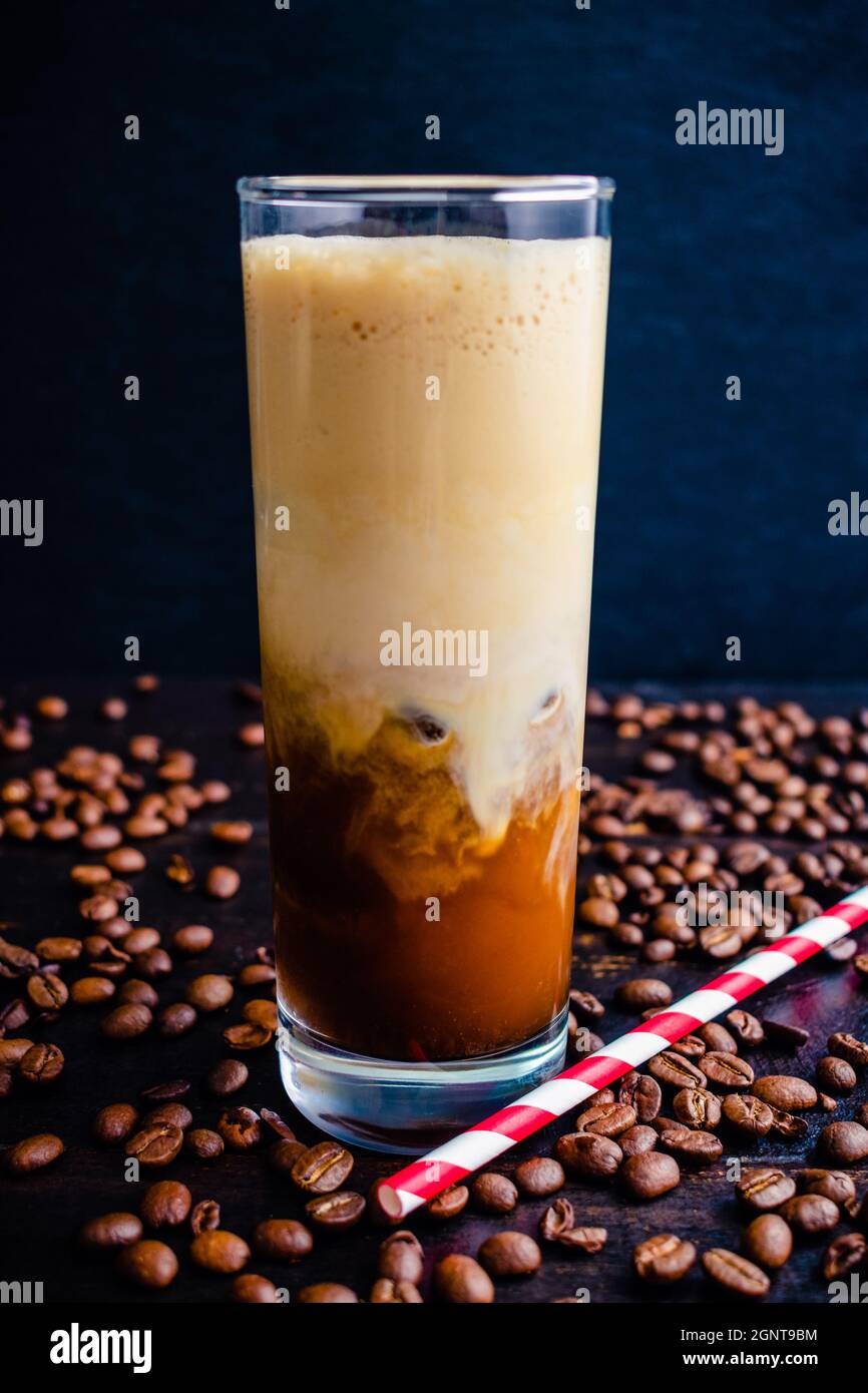 Iced Irish Coffee with Coffee Ice Cubes and Paper Straws Tall glass of