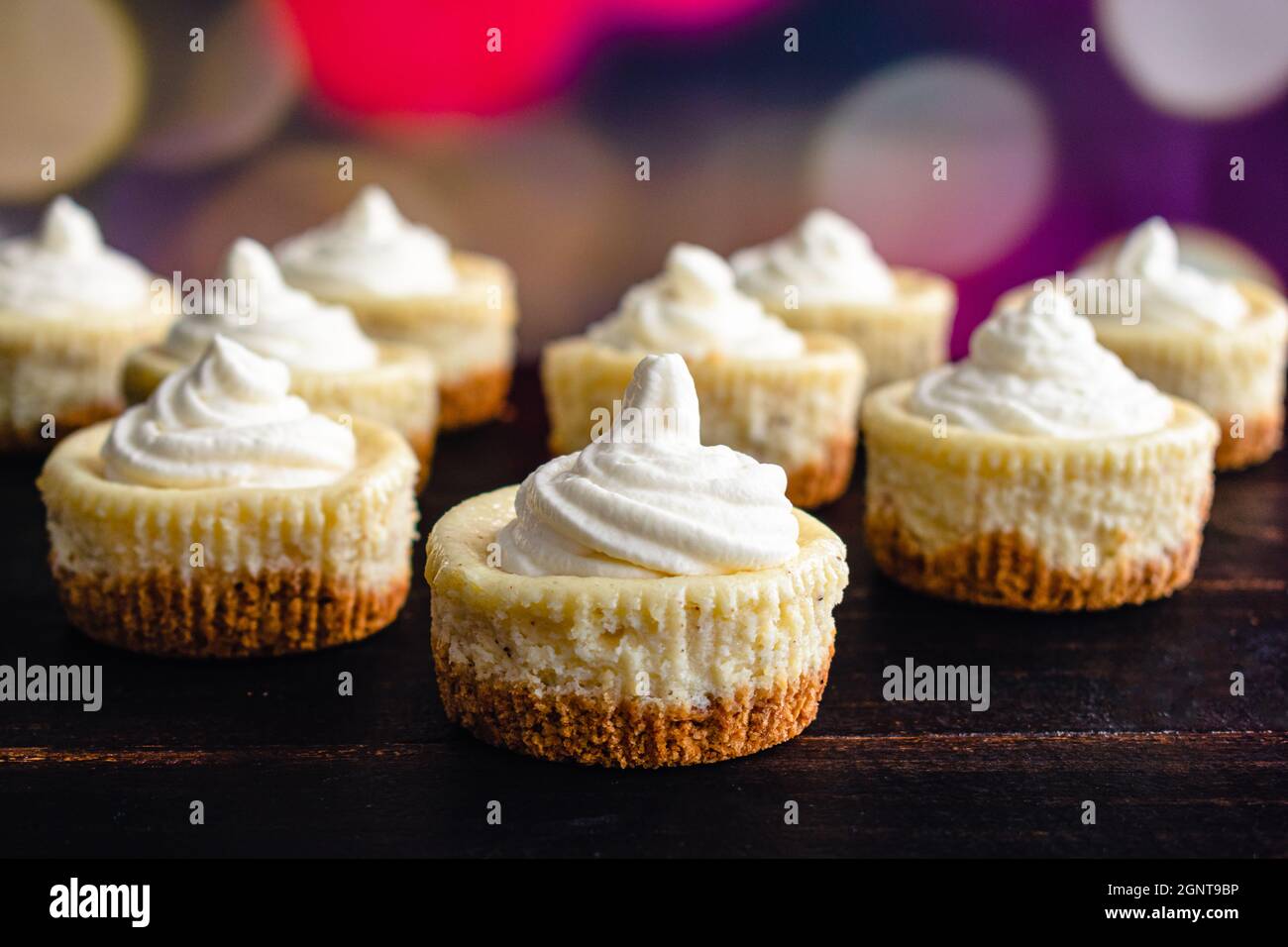 Mini Eggnog Cheesecakes Topped with Whipped Cream Eggnog cheesecake cupcakes with a Christmas
