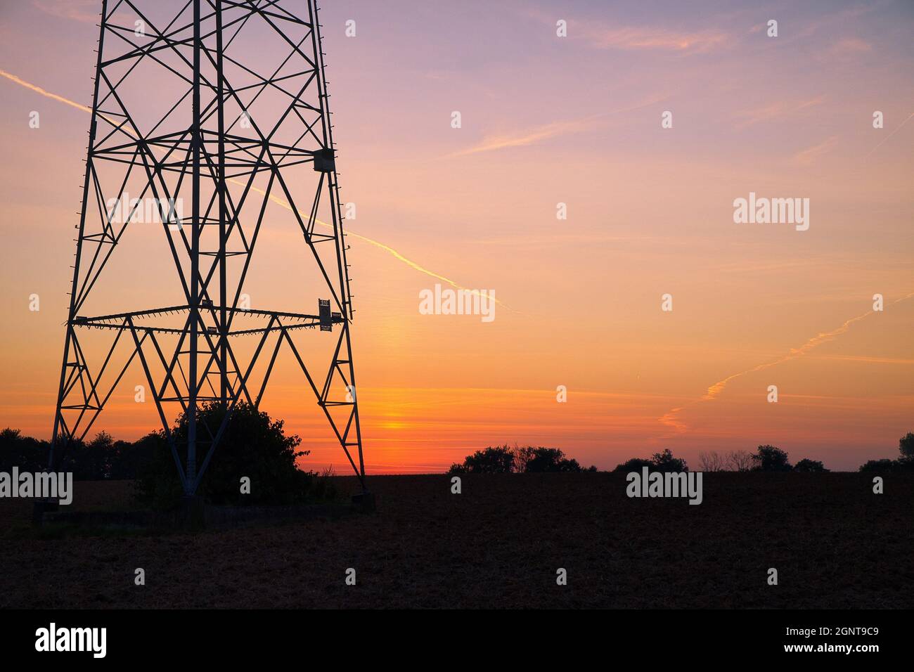 Transmission tower silhouette at sunset Stock Photo - Alamy