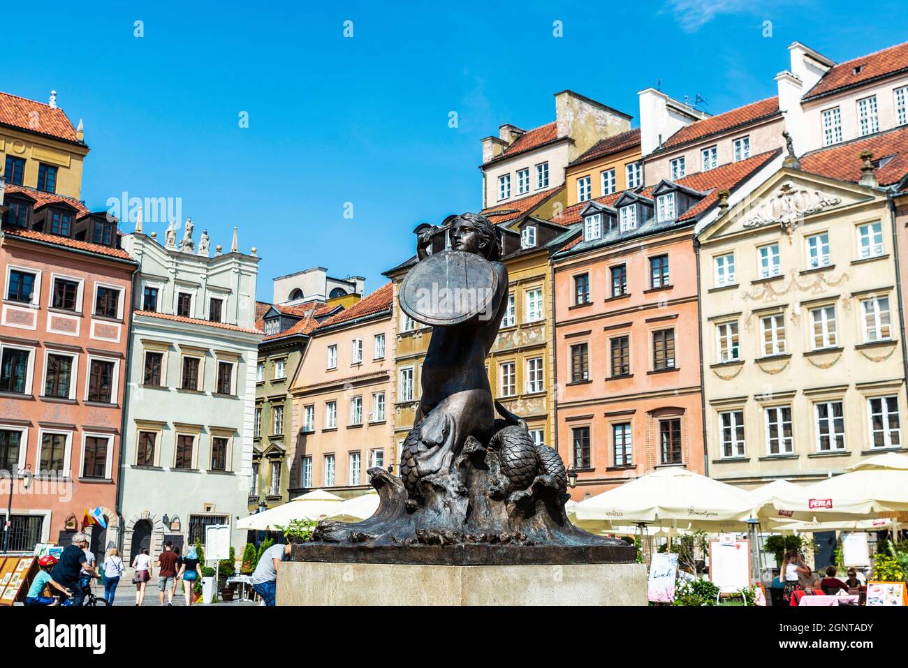 Warsaw, Poland - September 1, 2018: Syrenka or mermaid statue in the Old Town Market Place or Rynek Starego Miasta with bar and restaurants and people Stock Photo