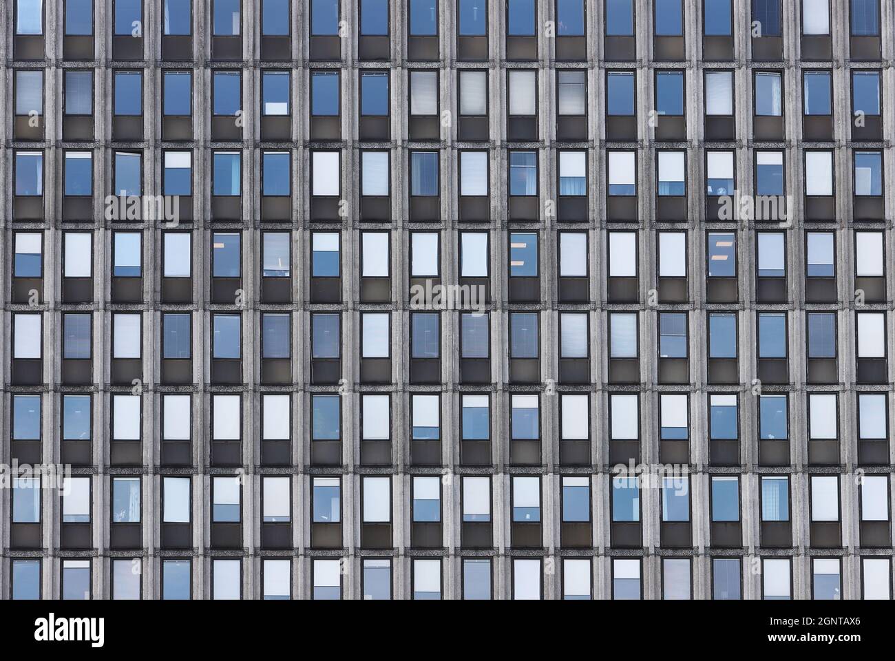 Full frame view of an office building facade with a pattern of windows. Stock Photo