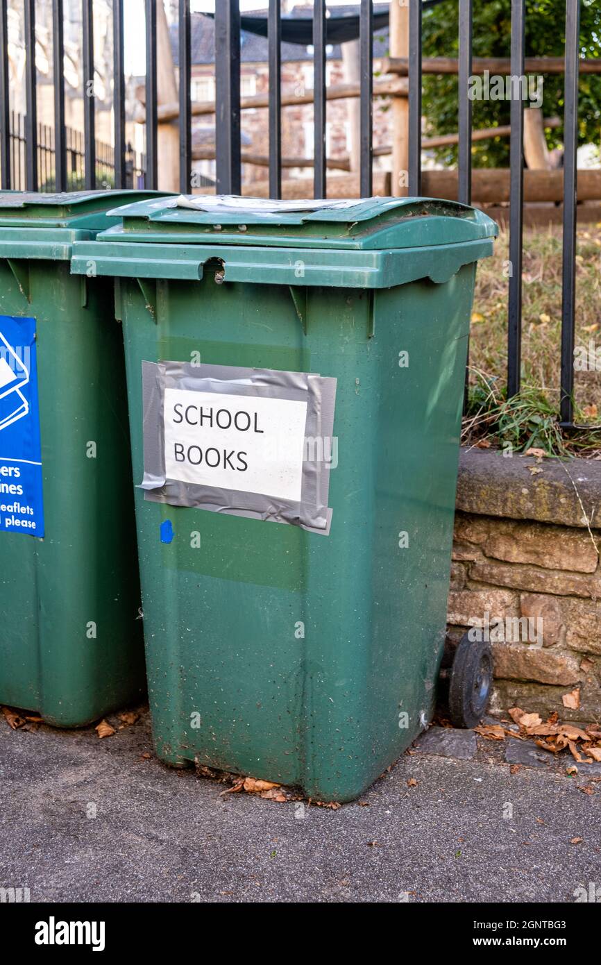 Green bin being used to collected old and used books for recycling