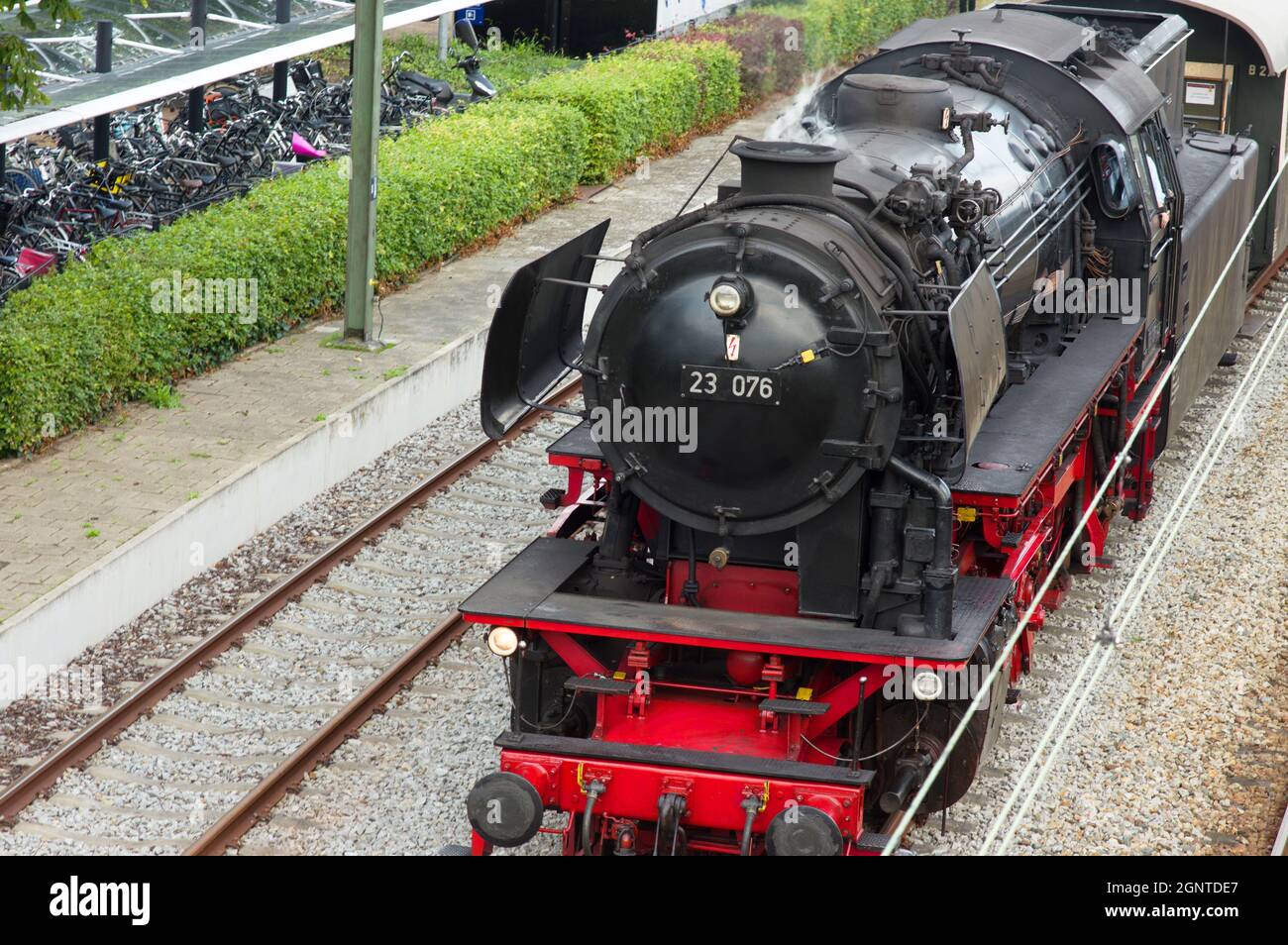 Old historic steam black locomotive with red wheels at station Dieren ...