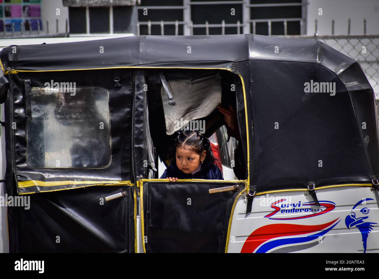 A small kid in a bike cab in Cumbal - Nariño, Colombia on August 15, 2021. Stock Photo