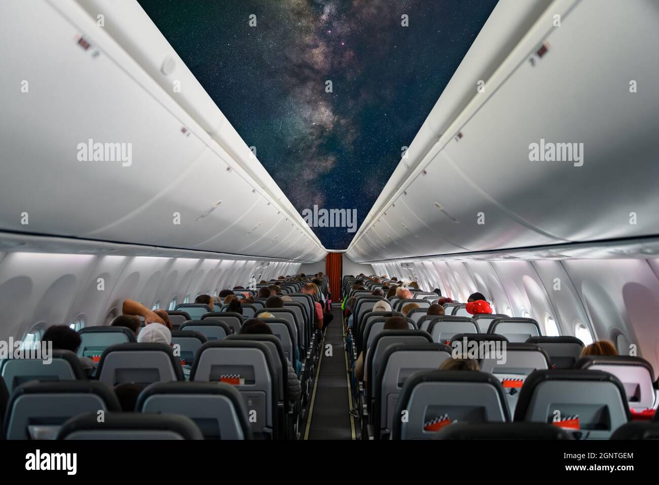 Photo of the aircraft interior with star and Milky way on ceiling of the airplane Stock Photo