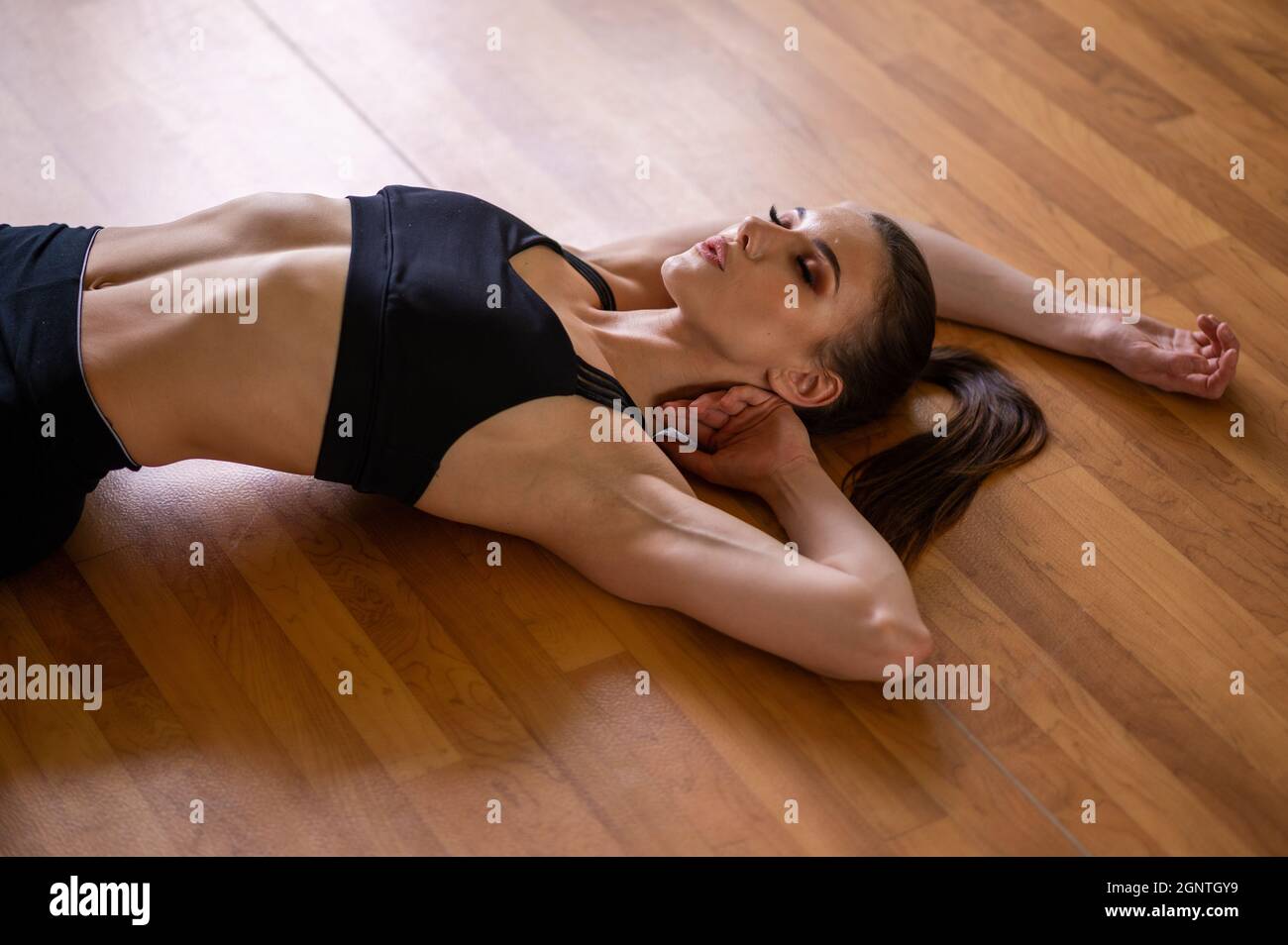 young fitness model stands in the gym opposite the mirror Stock Photo