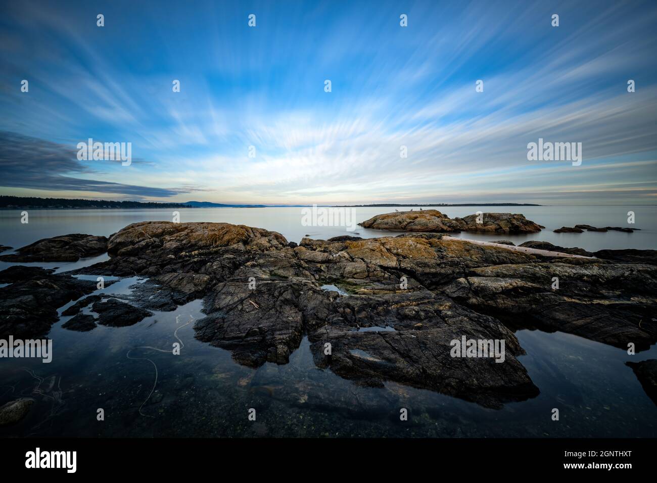 Scenic view of rocks and a blue ocean in Cattle point park in Canada ...