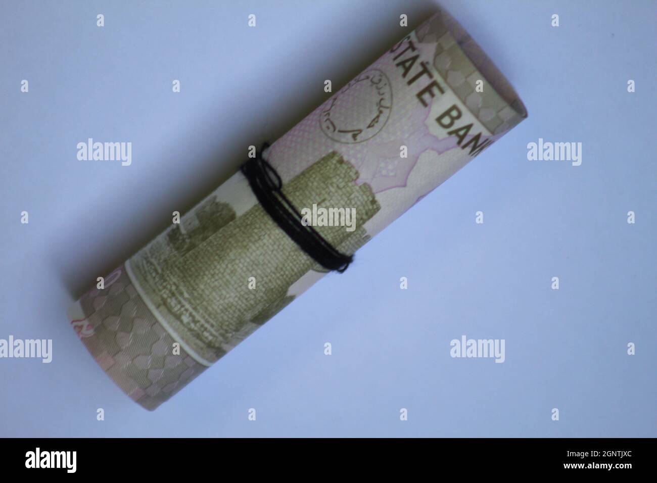 Currency notes in Pakistani Rupees - 10 Rupees note isolated n white background.High angle top view roll Stock Photo