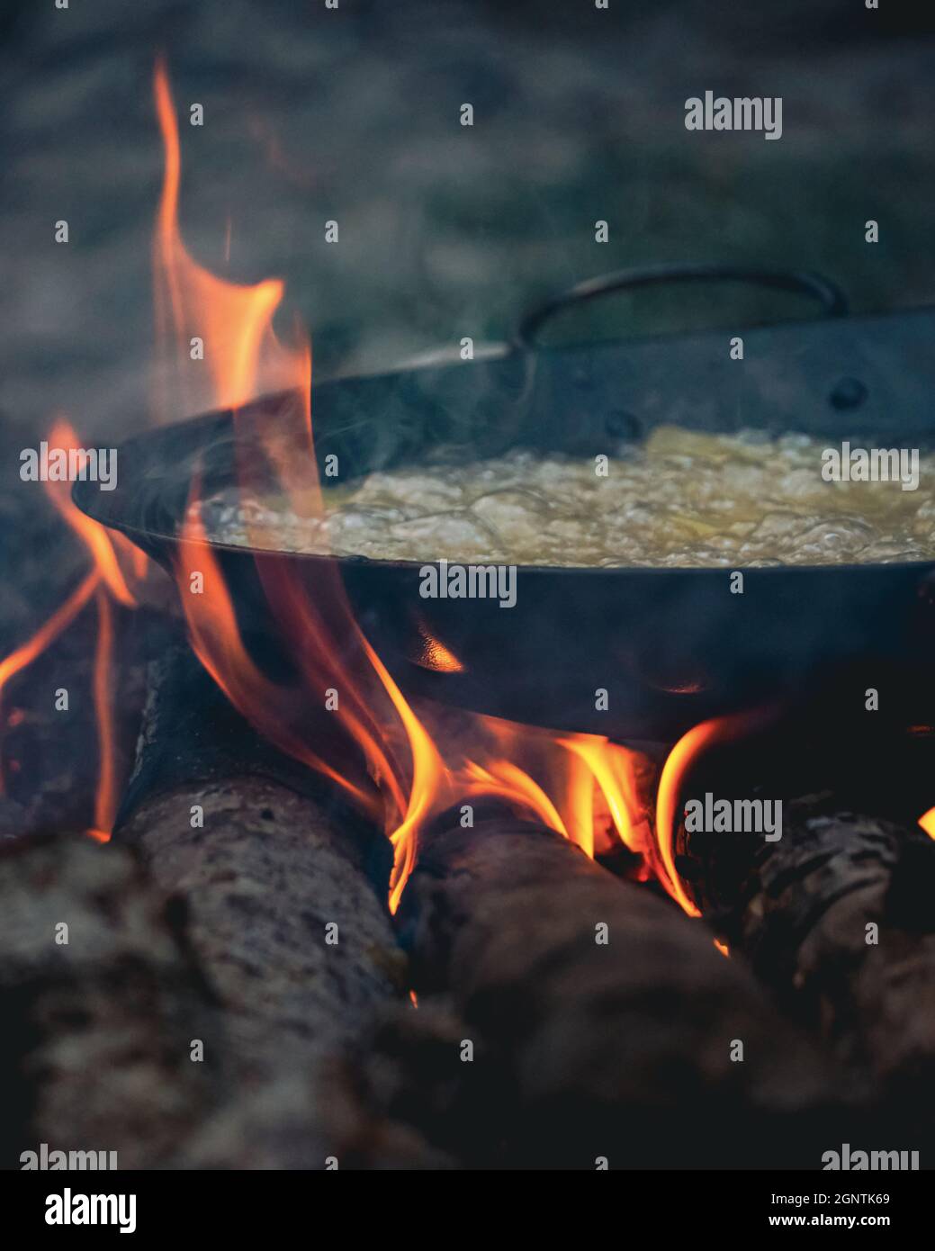 frying pan with boiling oil in it on the campfire Stock Photo Alamy