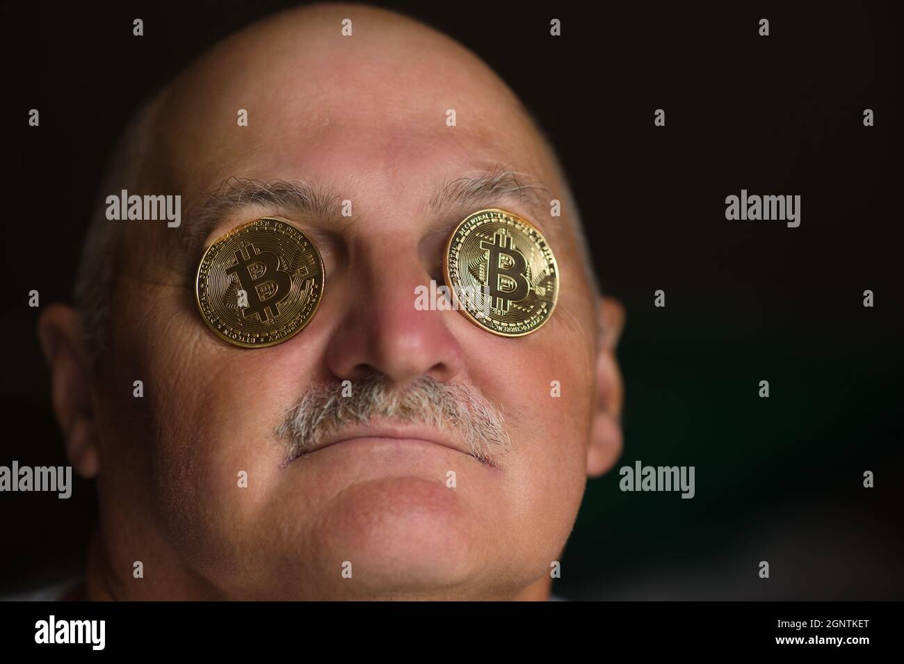 old man with bitcoin coins in eyes Stock Photo - Alamy
