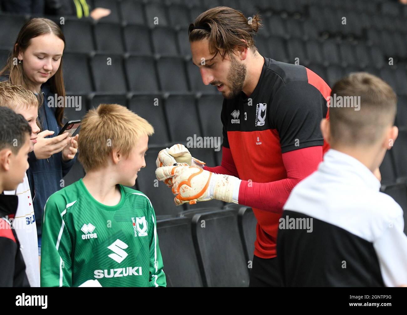 MILTON KEYNES, ENGLAND - SEPTEMBER 25, 2021: Franco Nahuel Ravizzoli of Dons signs a fan's jersey ahead of the 2021/22 SkyBet EFL League One matchweek 9 game between MK Dons FC and Wycombe Wanderers FC at Stadium MK. Copyright: Cosmin Iftode/Picstaff Stock Photo