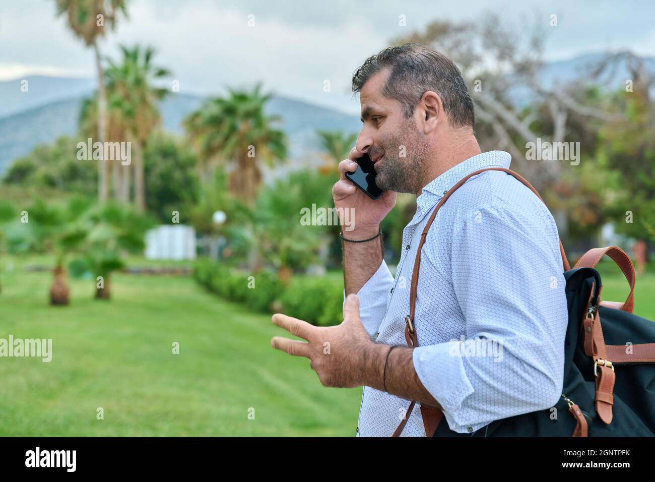 Mature business man talking on the phone outdoors Stock Photo