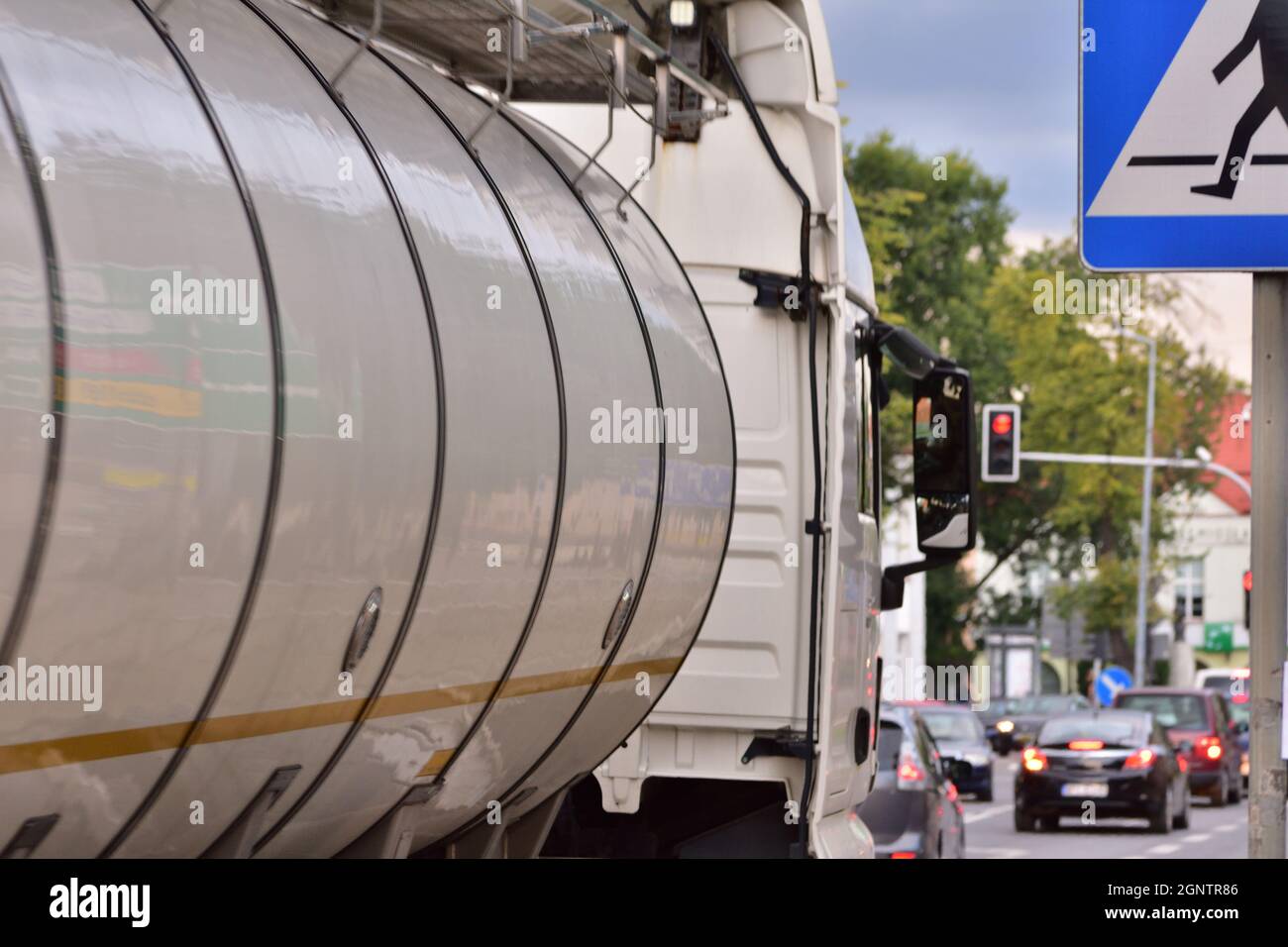 Tanker trucks are stuck in a traffic jam at a red light at an intersection. Intersection of light. Stock Photo