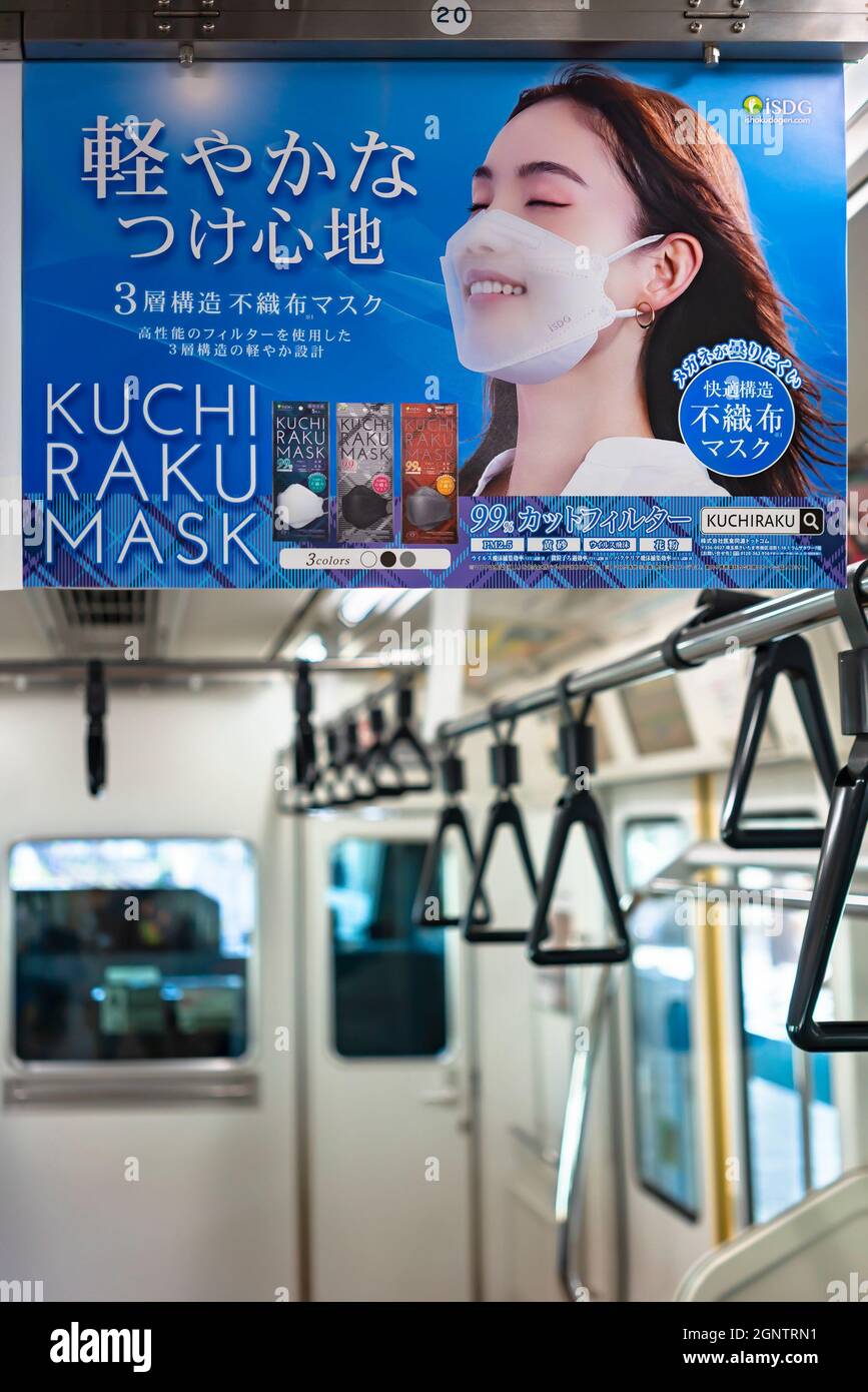 tokyo, japan - august 30 2021: Closeup on a Japanese advertising poster in a train depicting a smiling woman wearing a fashionable facial chirurgical Stock Photo
