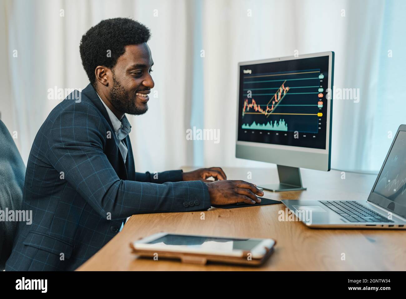 Black man working with binary option Stock Photo