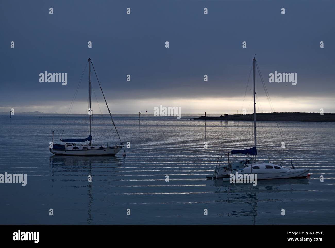 two sail boats rest at their moorings in Nelson, New Zealand Stock