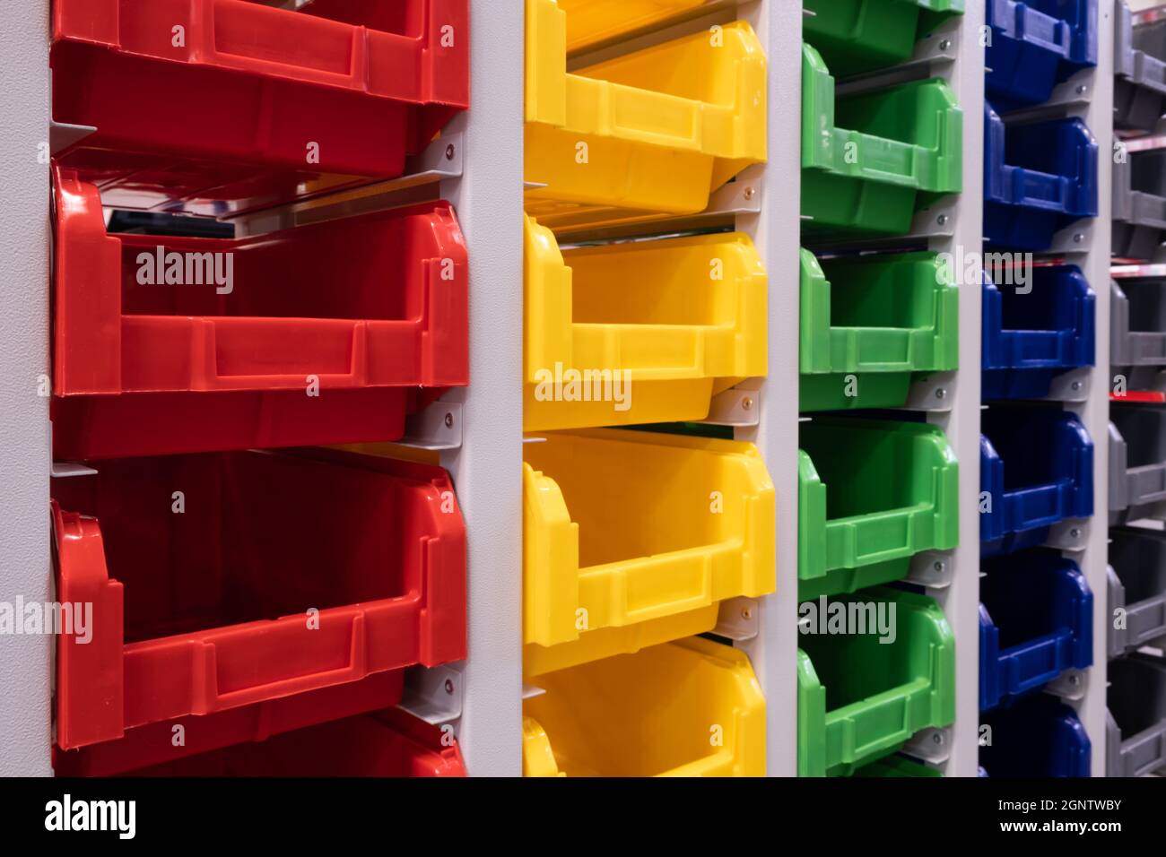 rows of multicolored plastic boxes for components Stock Photo