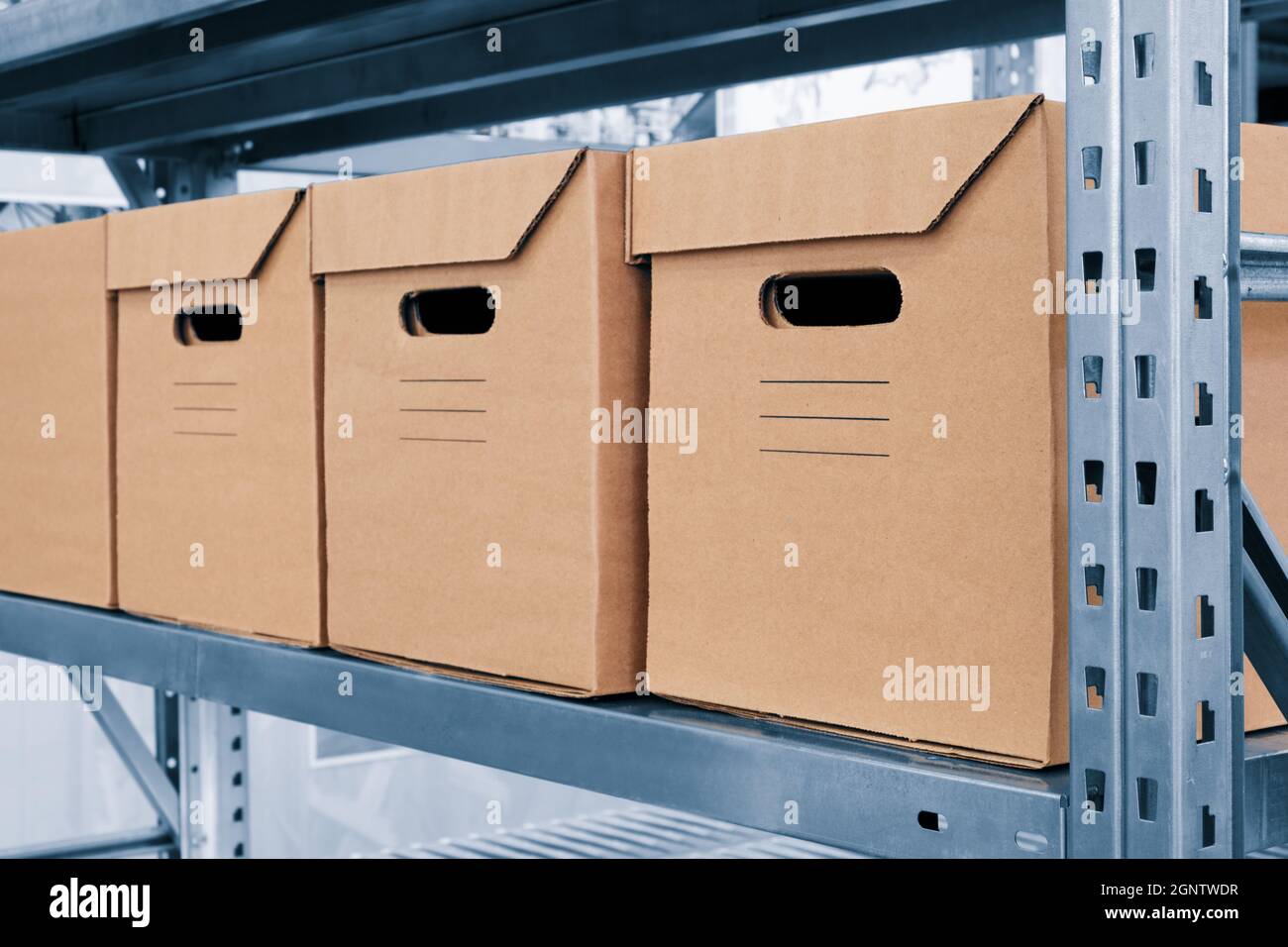 warehouse interior with cardboard boxes on shelves close up Stock Photo ...