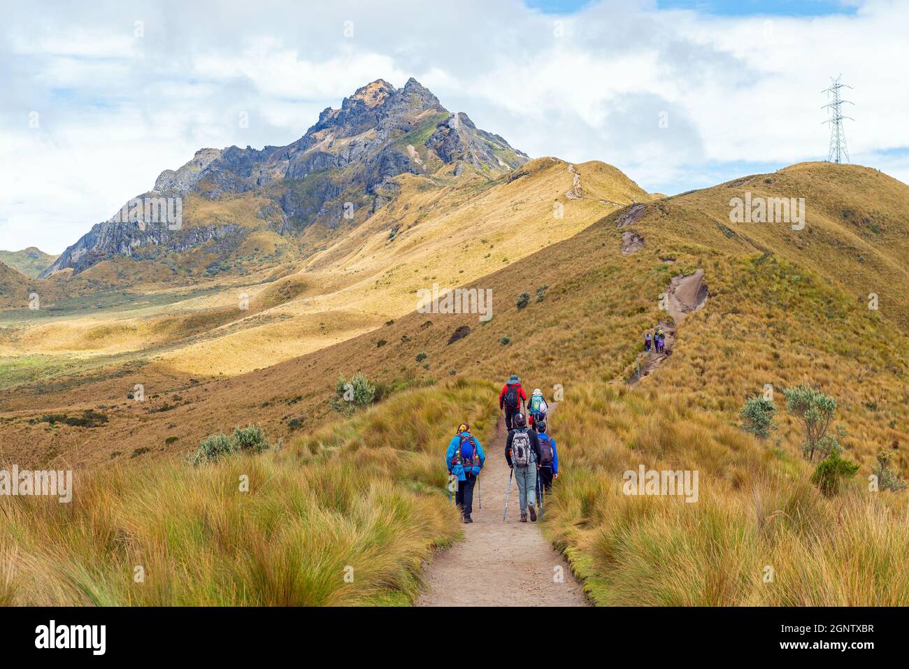 Small group of people with backpack hiking the Rucu Pichincha hike to the 4696m high Andes peak, Pichincha volcano, Quito, Ecuador. Stock Photo