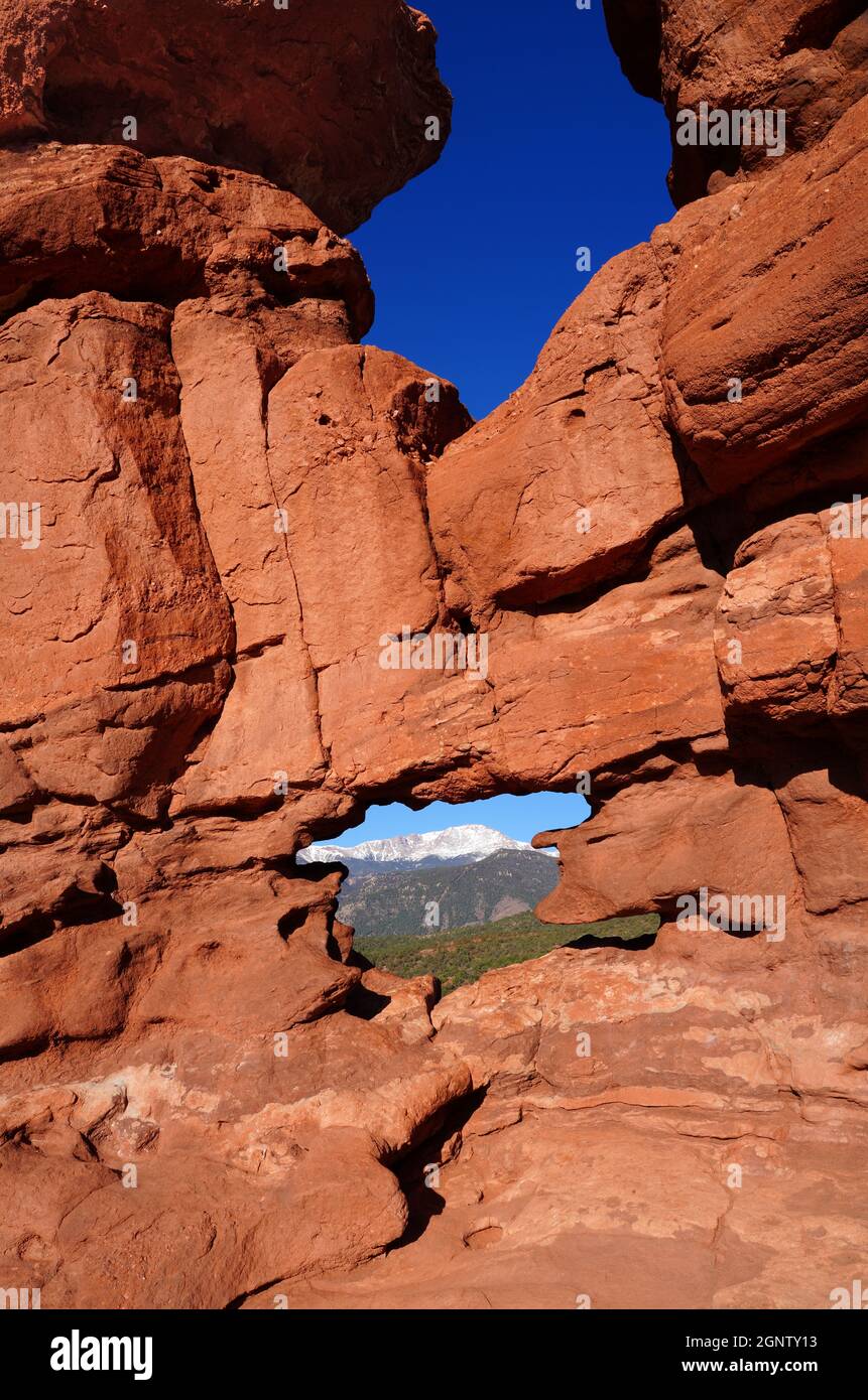 View Of Pikes Peak Through The Hole In The Siamese Twins Red Rock Formation In The Garden Of The Gods Park In Colorado Springs Colorado United State Stock Photo Alamy