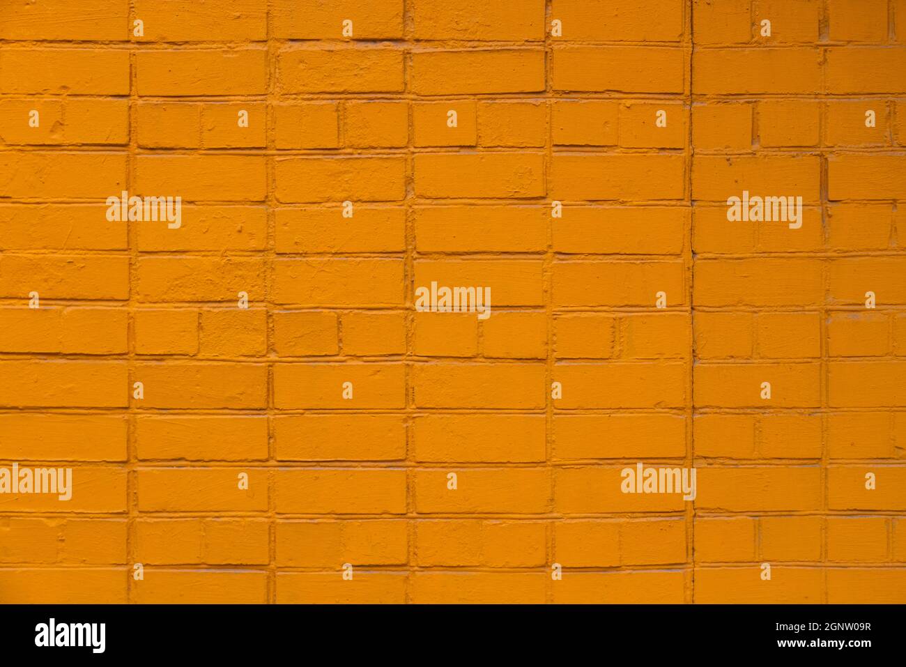 matte orange painted brick wall full frame flat background and texture Stock Photo