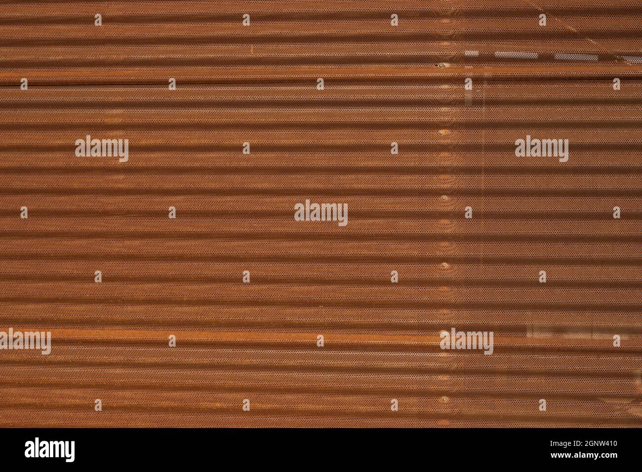 Perforated Rusty Corrugated Wall Background image Stock Photo