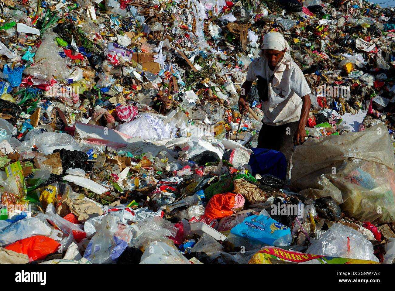 Angono, Rizal, Philippines. 24th Sep, 2021. This is Angono's dumpsite. A male scavenger digs into the pile of trash for items to be recycled or can be sold to a junk shop for a small amount of money. (Credit Image: © George Buid/ZUMA Press Wire) Stock Photo