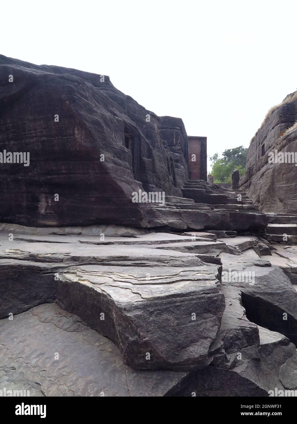 Eroded steps & cave openings along passage formed by natural canyon running east to west, Udayagiri Caves, Vidisha, India Stock Photo