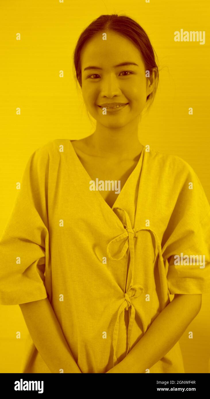 Duotone or half tone portrait of young Asian woman in studio looking at camera Stock Photo