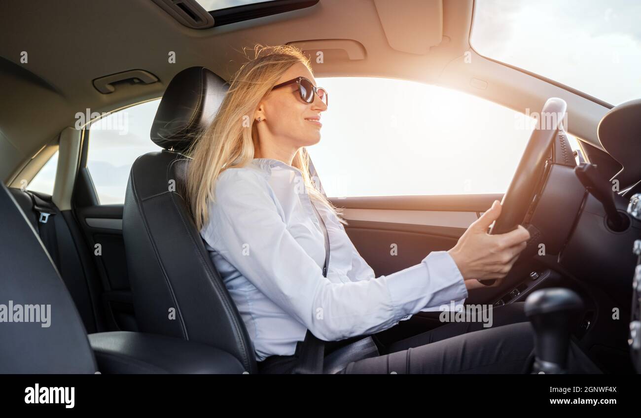 Business lady driving car Stock Photo - Alamy