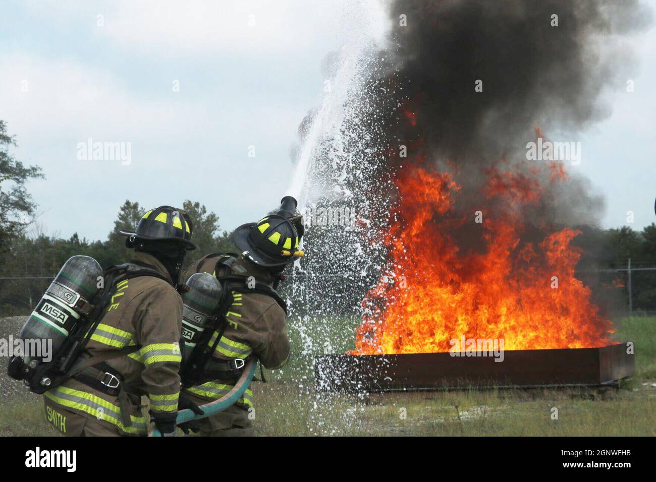 Firefighters Wilson Smith and Thomas Farst, Clarksville Fire Rescue, combat an outdoor fire Sept. 16 during Fire Fighter I and Fire Fighter II live fire practical evaluations at Fort Campbell Fire and Emergency Services’ training facility. Stock Photo