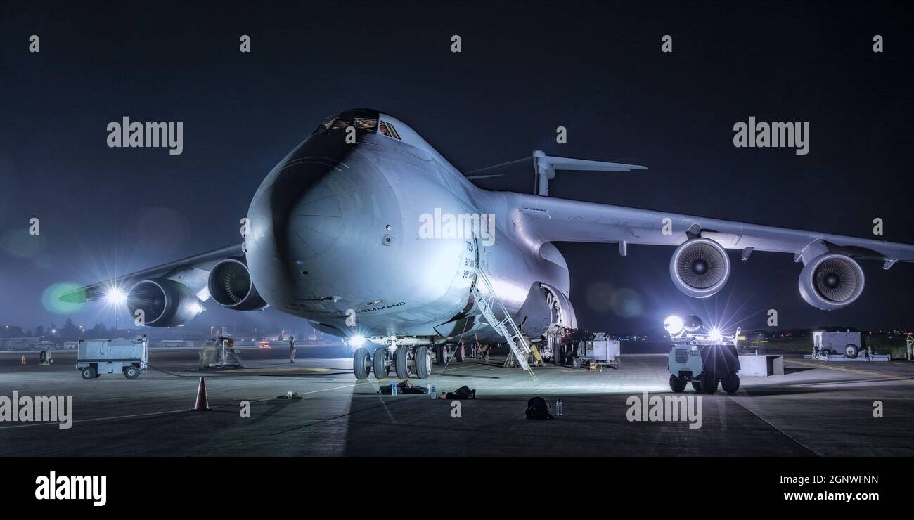 A C-5M Super Galaxy assigned to the 60th Air Mobility Wing, Travis Air Force Base, Calf. sits on the flightline at Yokota Air Base, Japan, Sept. 14, 2021. Airmen from the 730th Air Mobility Squadron participated in different training exercises including maintenance, inspections and loading capabilities in order to maintain mission readiness. Stock Photo