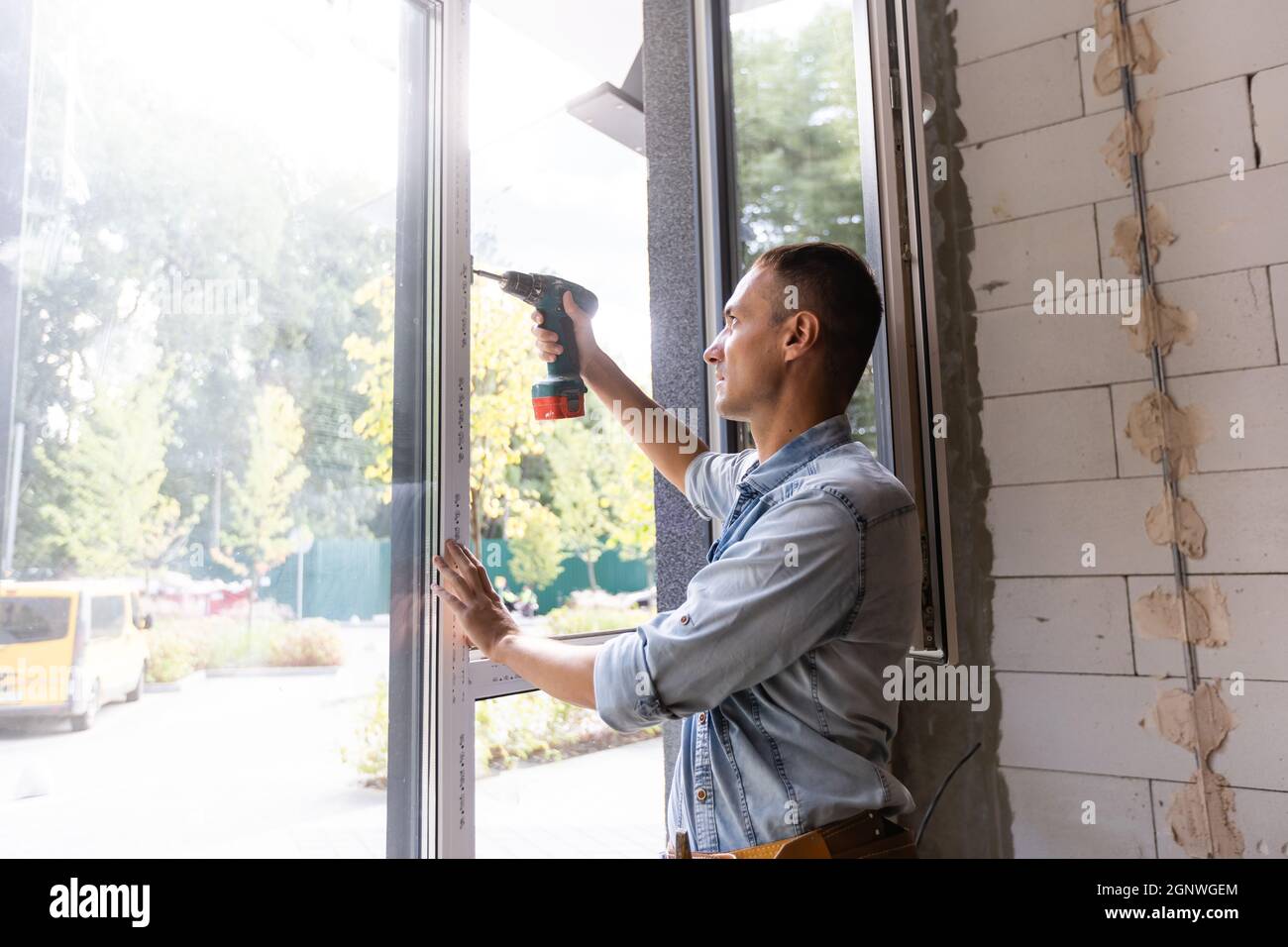 Male worker installing window in flat, closeup Stock Photo