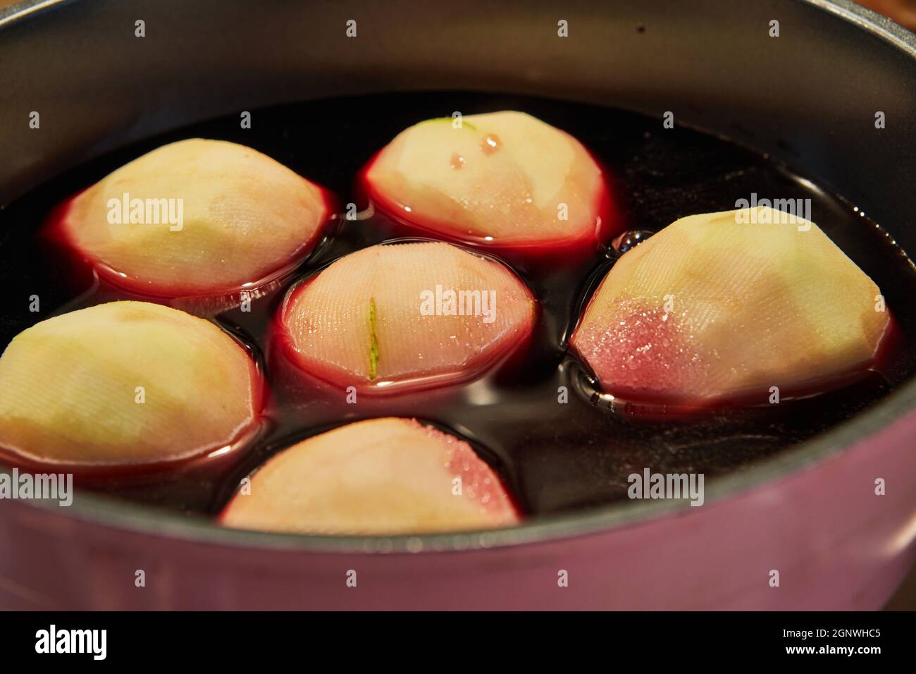 Pears are boiled in red syrup with wine on gas stove Stock Photo Alamy