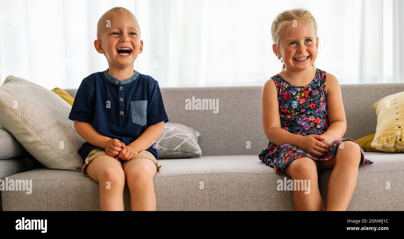 Preschool children boy and girl sit together. Happy childhood, parenting, kid concept. Stock Photo